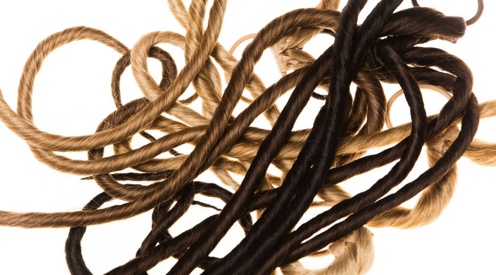 Easy Updo ponytail extensions in a pile from blonde to brown to black and red