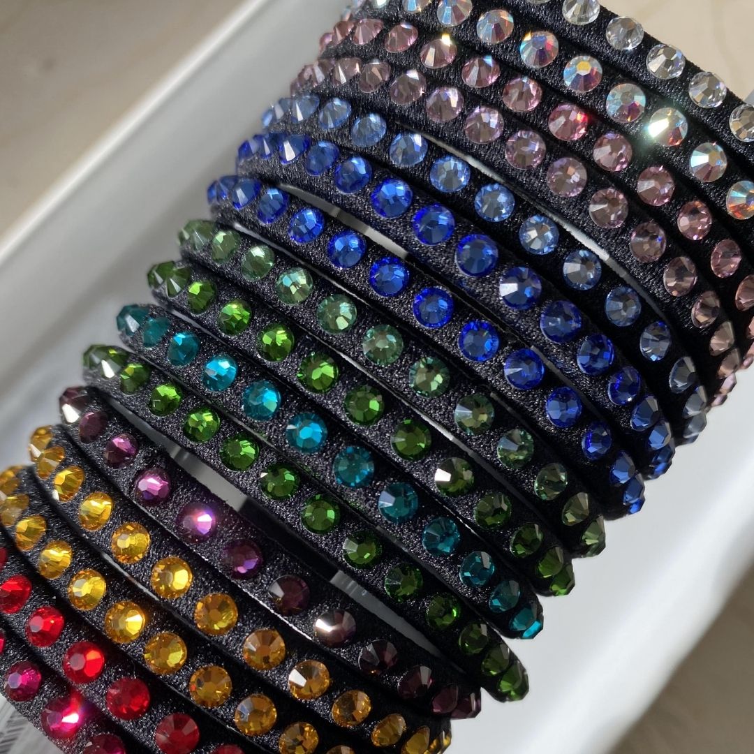 Swarovski Elements Crystal hair elastics in a rainbow of colors from clear to red to emerald to sky blue.