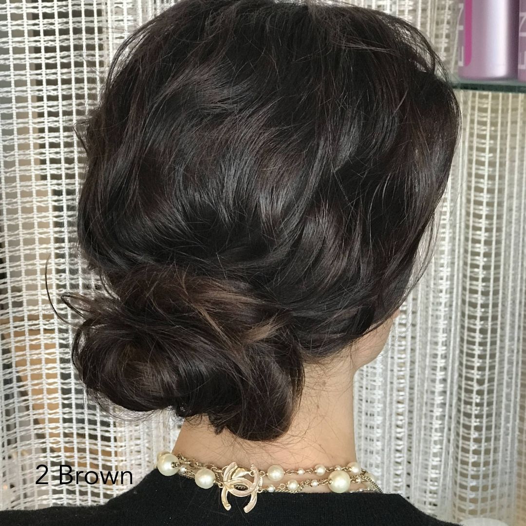 Textured Brown Bun of woman wearing a black shirt with a Chanel Gold Necklace and Easy Updo Extensions mixed with her hair